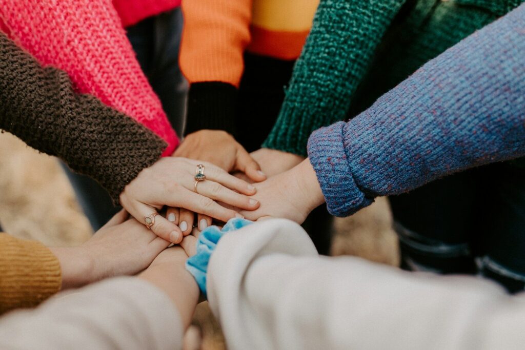 Team bonding activities in Malaysia — colleagues stacking hands together
